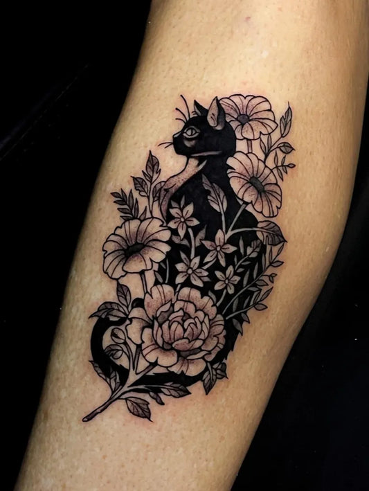 Medium Blackwork Cat and Flowers Tattoo on Women Arm by @ink.yona