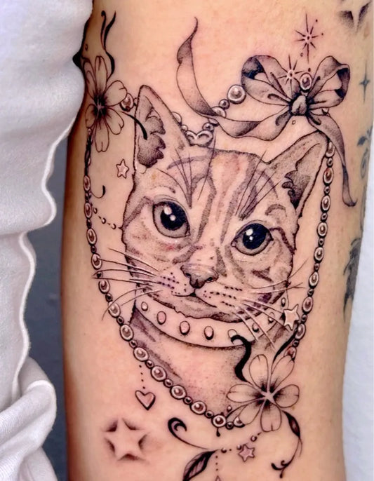 Medium Blackwork Cat with Necklace and Flowers Tattoo on Women Arm by @miss_preciouss