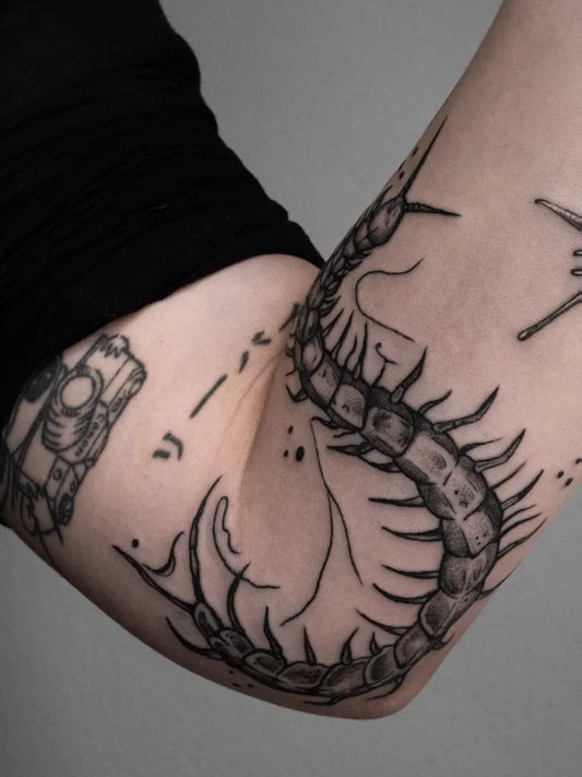 Medium Blackwork Centipede Tattoo on Women Arm by @nastya.tatts