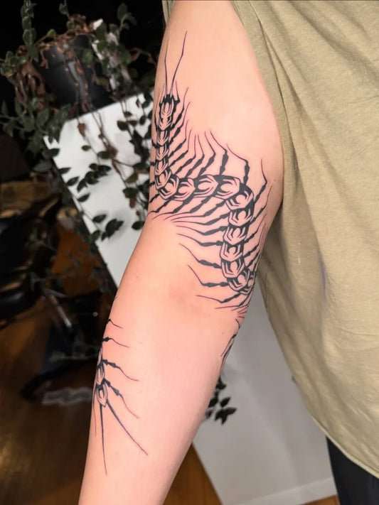 Medium Blackwork Centipede Tattoo on Women Arm by @sooji.tattoo