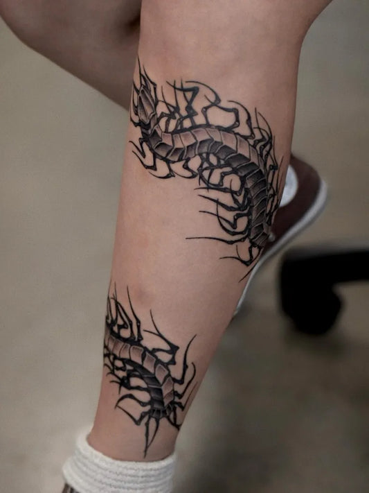 Medium Blackwork Centipede Tattoo on Women Leg by @gary.tattooer