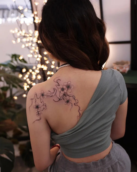 Medium Blackwork Cherry Blossom on Women Back Tattoo by @vivi_tattooer