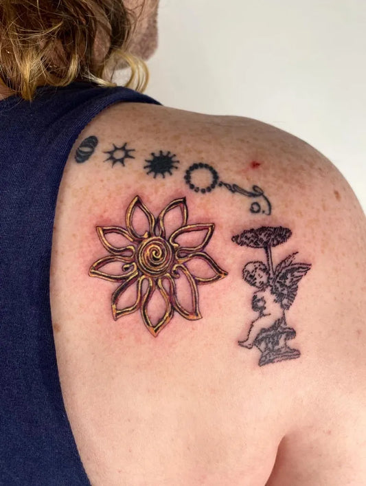Medium Blackwork Cherub Flower Tattoo on Men Shoulder by @shell_station_tattoo