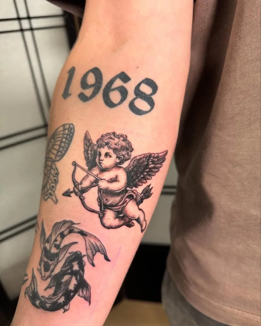 Medium Blackwork Cherub Koi Tattoo on Men Arm by @garfol.tattoo
