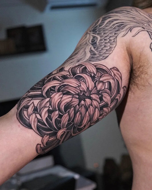 Medium Blackwork Chrysanthemum and Dragon Tattoo on Men Arm by @coimaxtattoo