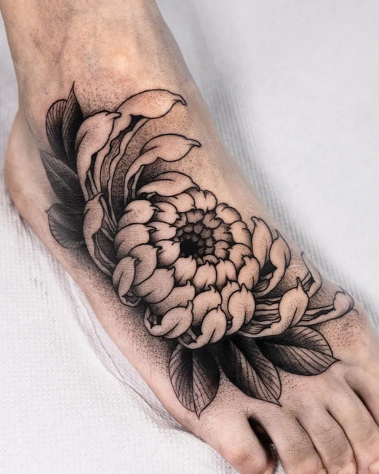 Medium Blackwork Chrysanthemum and Leaves Tattoo on Women Foot by @valentino.tattoos