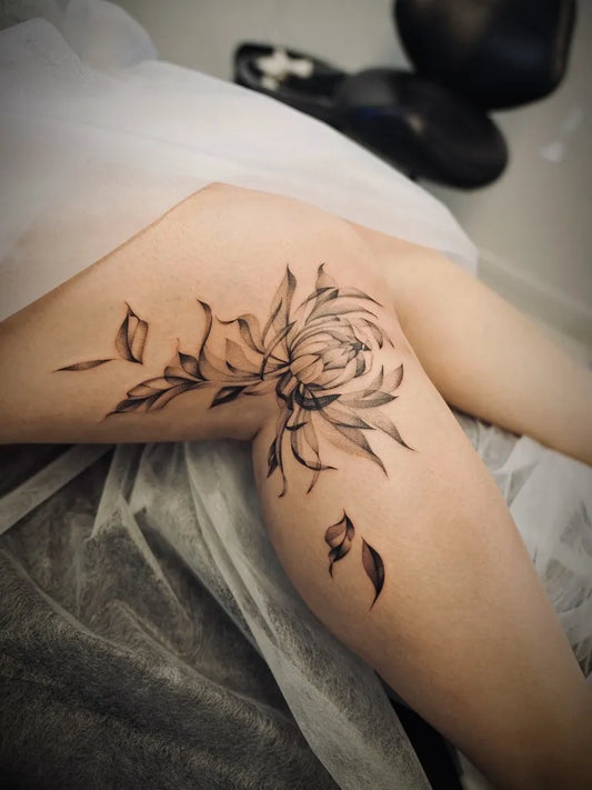 Medium Blackwork Chrysanthemum and Leaves Tattoo on Women Knee by @baronarttattoo