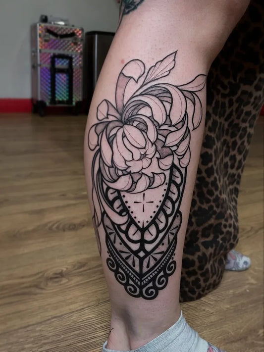 Medium Blackwork Chrysanthemum in Black Floral Mandala Tattoo on Women Leg by @chxrlieseye.ttt