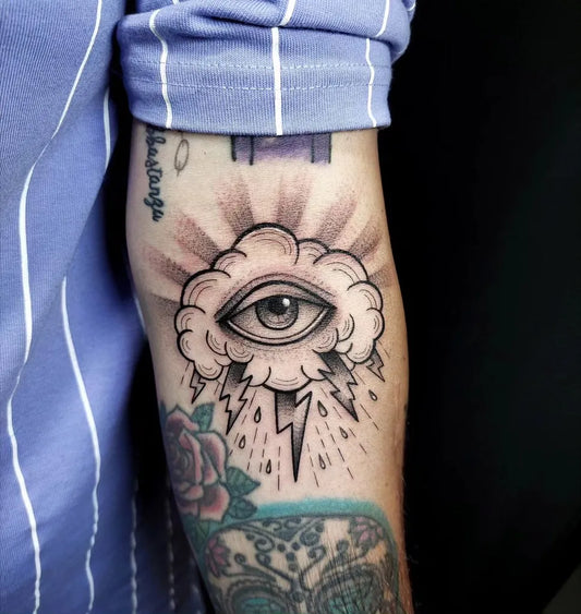 Medium Blackwork Cloud Eye Tattoo on Men Arm by @alessia.calarese_tat2