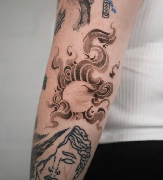 Medium Blackwork Cloud Face Tattoo on Women Arm by @tattlina