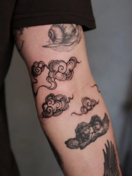 Medium Blackwork Clouds and Snail Tattoo on Men Arm by @imsumimi