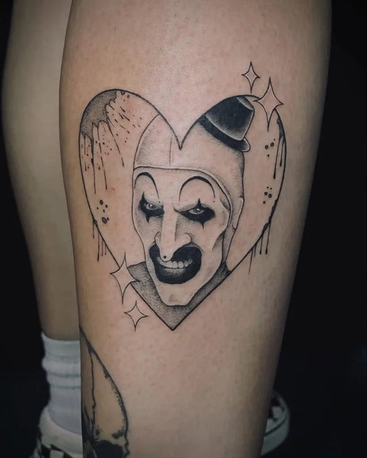 Medium Blackwork Clown Heart Horror Tattoo on Women Leg by @bams.ink