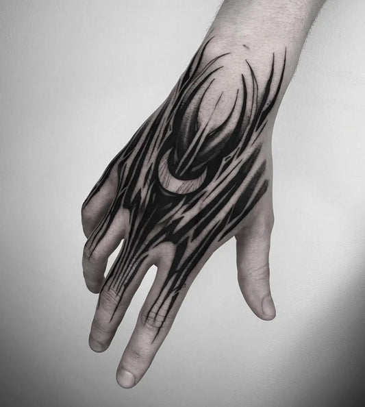 Medium Blackwork Crescent Moon and Tribal Lines Tattoo on Men Hand by @southgatetattoo