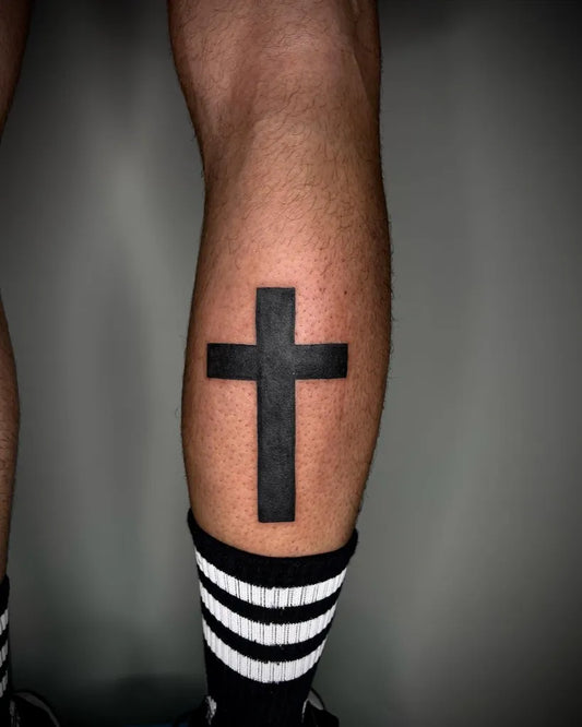 Medium Blackwork Cross on Men Leg Tattoo by @elena_puffo_brontolone