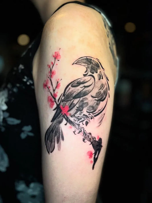 Medium Blackwork Crow and Cherry Blossom Tattoo on Women Shoulder by @jaelee.ink