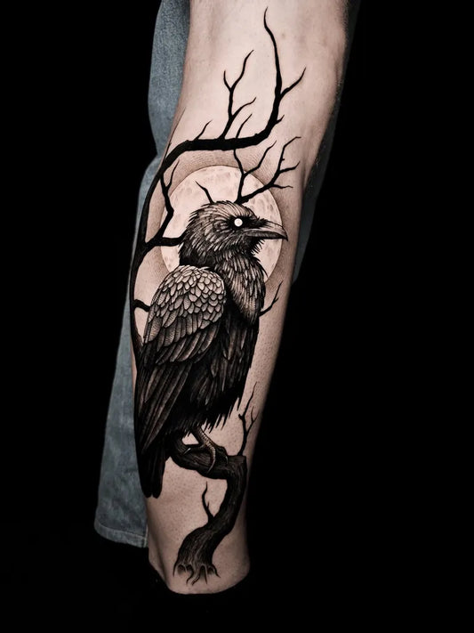 Medium Blackwork Crow on Tree Branch Tattoo on Men Arm by @grandson_tattooink