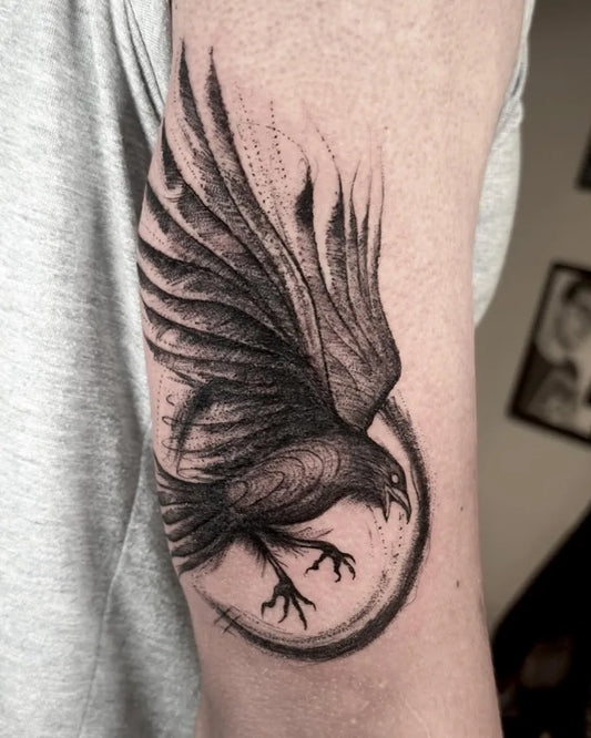 Medium Blackwork Crow with Wings and Circle Men Arm by @daniela.moreno.l