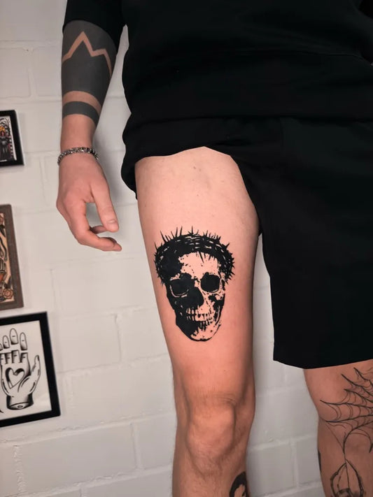 Medium Blackwork Crown of Thorns Skull Tattoo on Men Thigh by @quentin_tattoorino