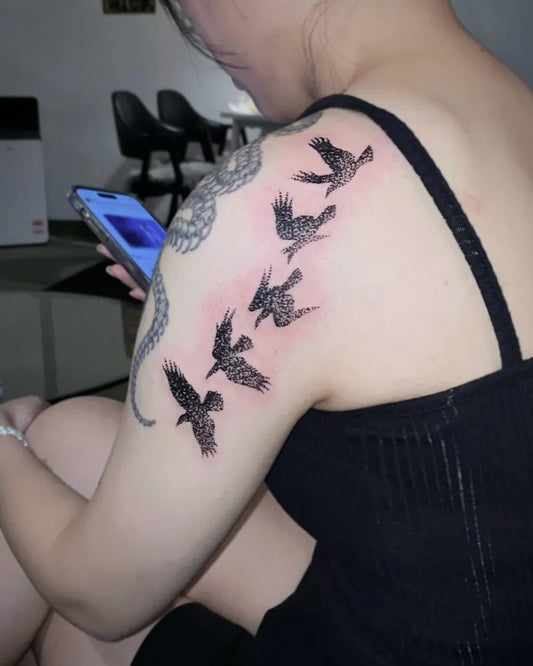 Medium Blackwork Crows and Snake Tattoo on Women Shoulder by @h_tattooer