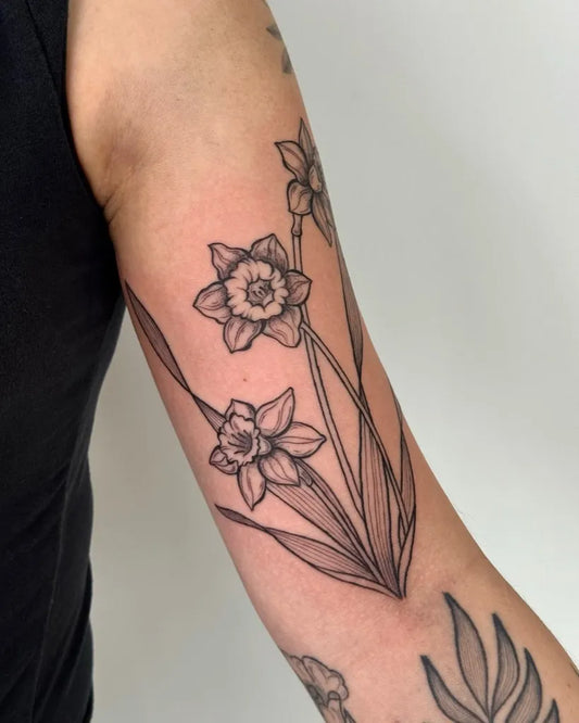 Medium Blackwork Daffodil Flowers Tattoo on Women Arm by @tattoo.mariah