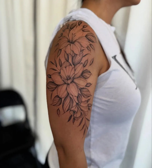 Medium Blackwork Daffodil Flowers Tattoo on Women Shoulder by @inkedbyjules_