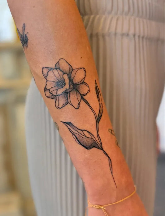 Medium Blackwork Daffodil Tattoo on Women Arm by @koscaro_ink