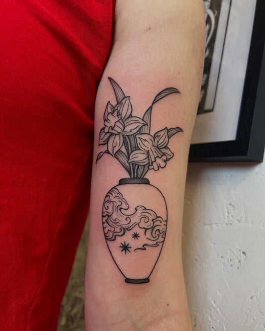 Medium Blackwork Daffodil Vase Tattoo on Women Arm by @froggiemaggie.tattoo