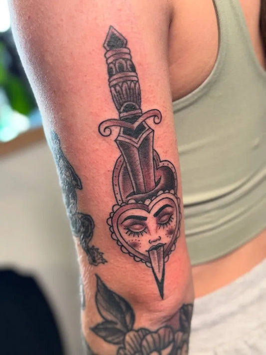Medium Blackwork Dagger Heart Tattoo on Women Arm by @artbyphoenixx