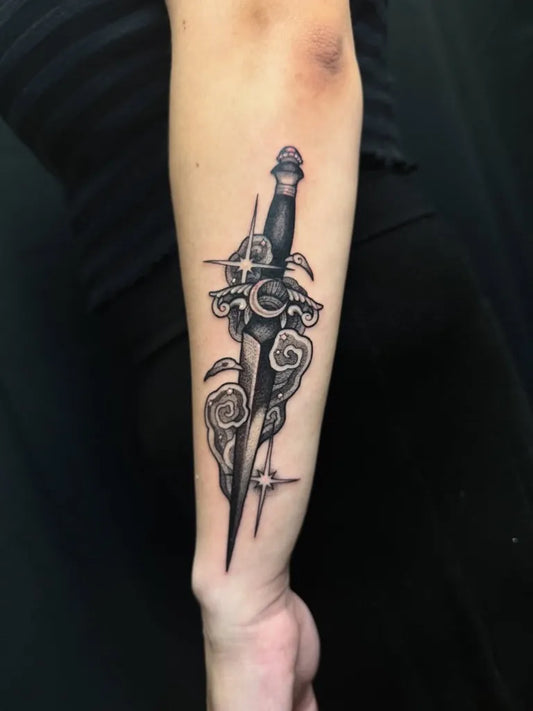 Medium Blackwork Dagger and Lotus Tattoo on Women Arm by @beaudiccas