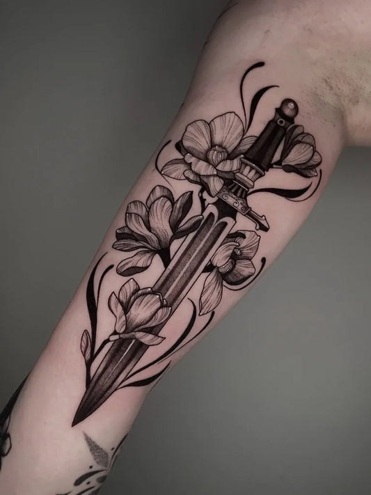 Medium Blackwork Dagger and Magnolia Women Arm Tattoo on Women by @_hannatattoo_