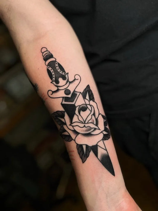 Medium Blackwork Dagger and Rose Tattoo on Men Arm by @buzniktattoo