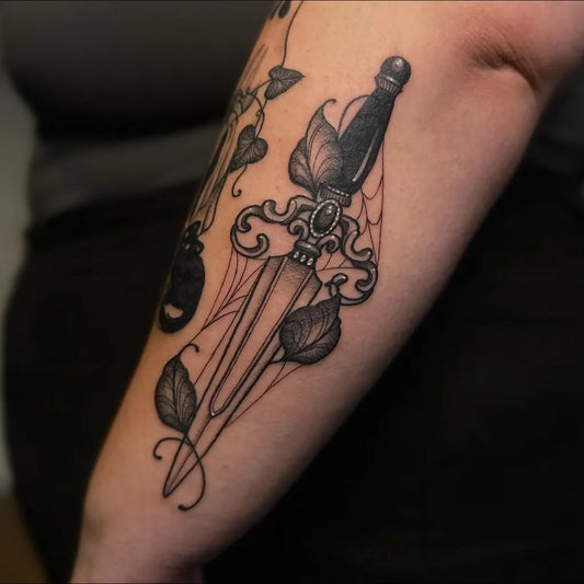 Medium Blackwork Dagger and Spiderweb Tattoo on Women Arm by @amyjo_tattoo