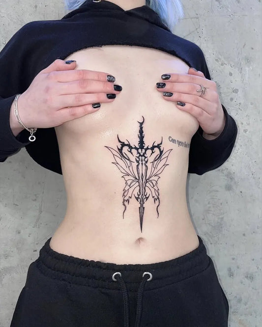 Medium Blackwork Dagger and Wings Tattoo on Women Stomach by @armin.agne