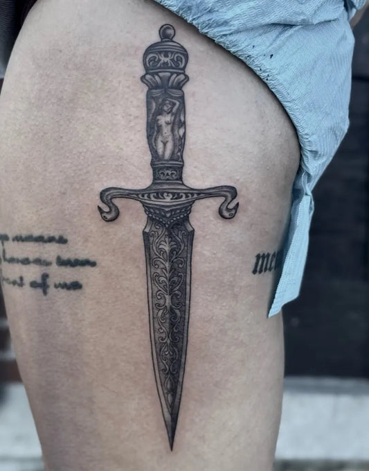 Medium Blackwork Dagger with Latin Inscription Tattoo on Women Thigh by @car_elanie
