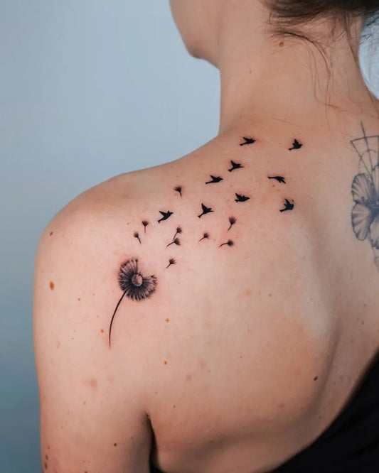 Medium Blackwork Dandelion and Birds Tattoo on Women Shoulder by @lano.ink
