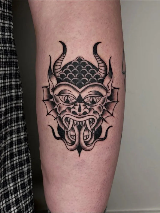 Medium Blackwork Demon Mask Tattoo on Men Arm by @crucibletattooco