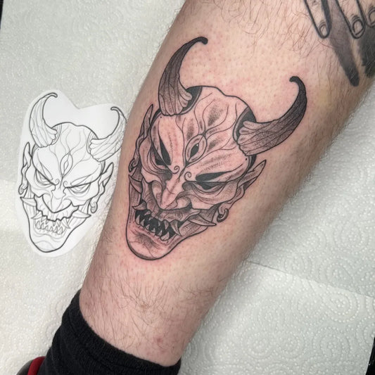 Medium Blackwork Demon Mask Tattoo on Men Thigh by @theblackhattattoo