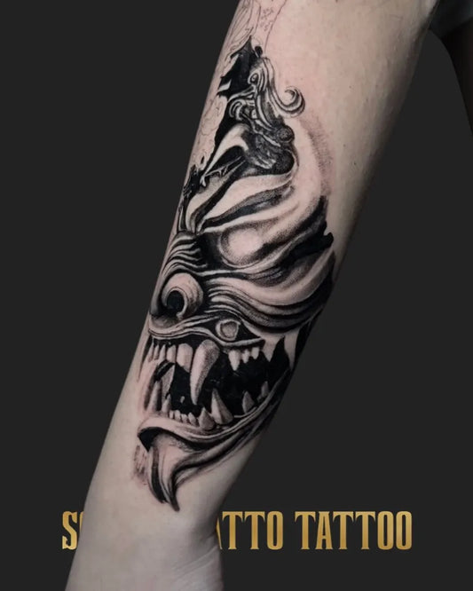 Medium Blackwork Demon Mask Tattoo on Women Arm by @scaccomattotattoo