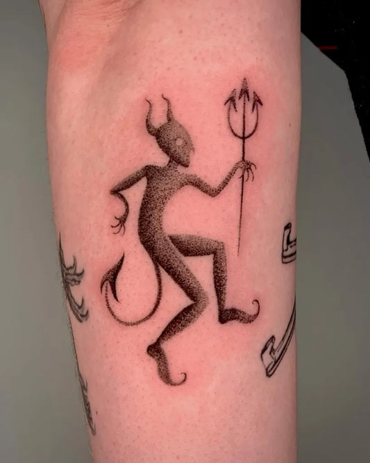 Medium Blackwork Demon with Trident and Skates Tattoo on Women Forearm by @char_tattoo