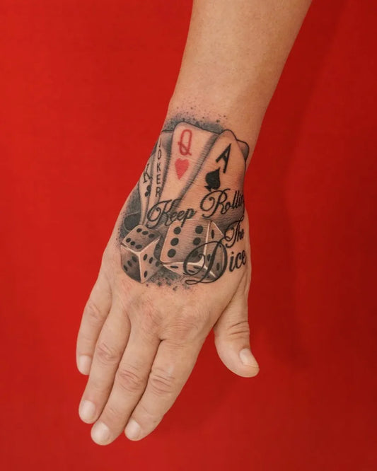 Medium Blackwork Dice and Cards Tattoo on Women Wrist by @dragoncityink.danang