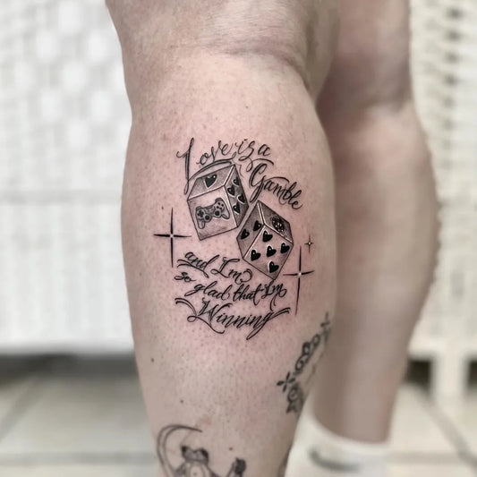 Medium Blackwork Dice and Script Tattoo on Women Thigh by @kieranlowetattoo