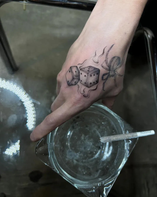 Medium Blackwork Dice and Smoke Tattoo on Women Hand by @bexysabe_tattoos