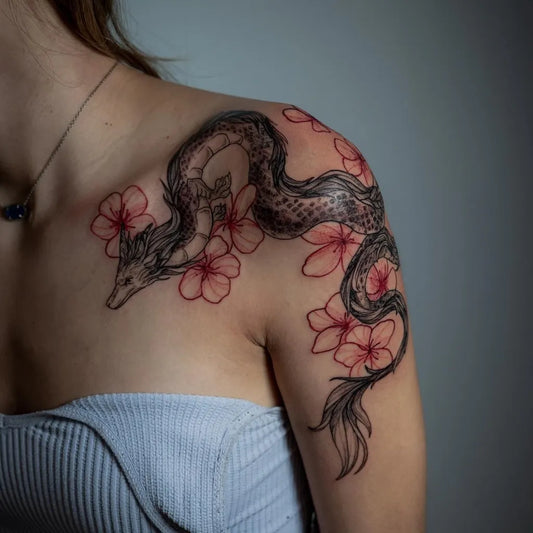 Medium Blackwork Dragon Cherry Blossom on Women Shoulder Tattoo by @mariia.lines