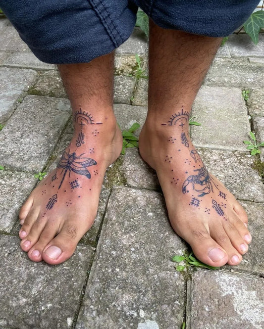 Medium Blackwork Dragonfly Feathers Tattoo on Men Foot by @artbyaimeedaniels