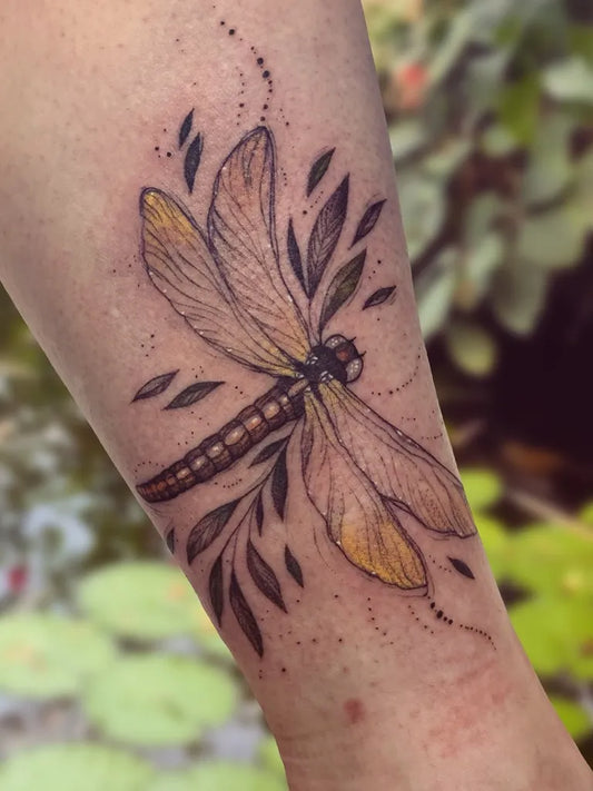 Medium Blackwork Dragonfly and Leaves on Women Arm Tattoo by @marta_vinni_tattoo