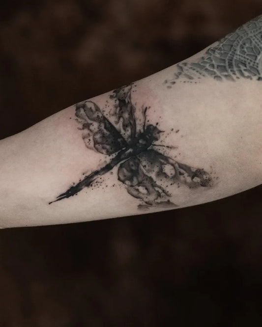Medium Blackwork Dragonfly on Women Arm Tattoo by @inkfinite