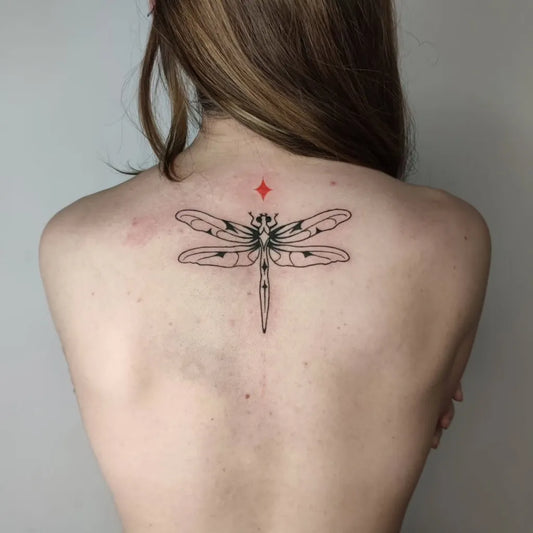 Medium Blackwork Dragonfly with Star on Women Back Tattoo by @kit_katei