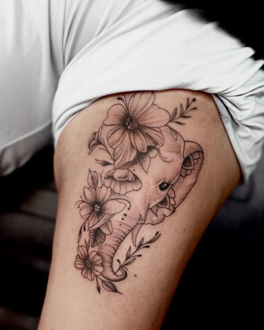 Medium Blackwork Elephant and Flowers Tattoo on Women Shoulder by @oldsoulsink
