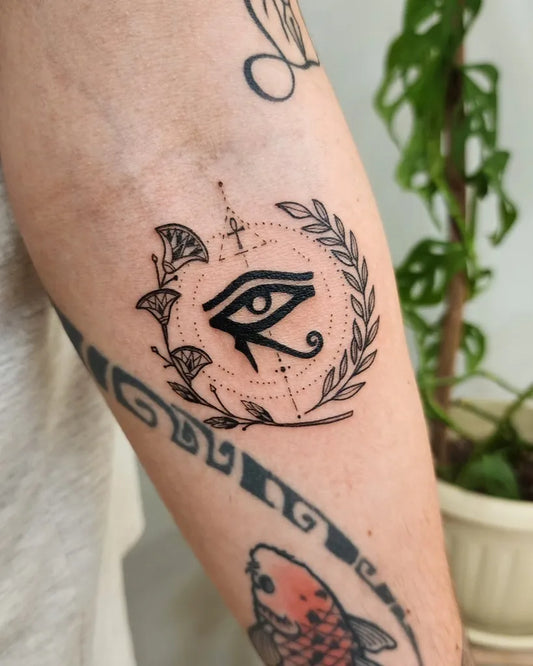 Medium Blackwork Eye of Horus with Laurel Wreath Tattoo on Men Arm by @daniel.nabil_ink