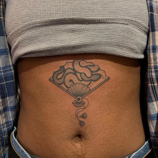 Medium Blackwork Fan Tattoo on Women Stomach by @emy.noemie.tattoo